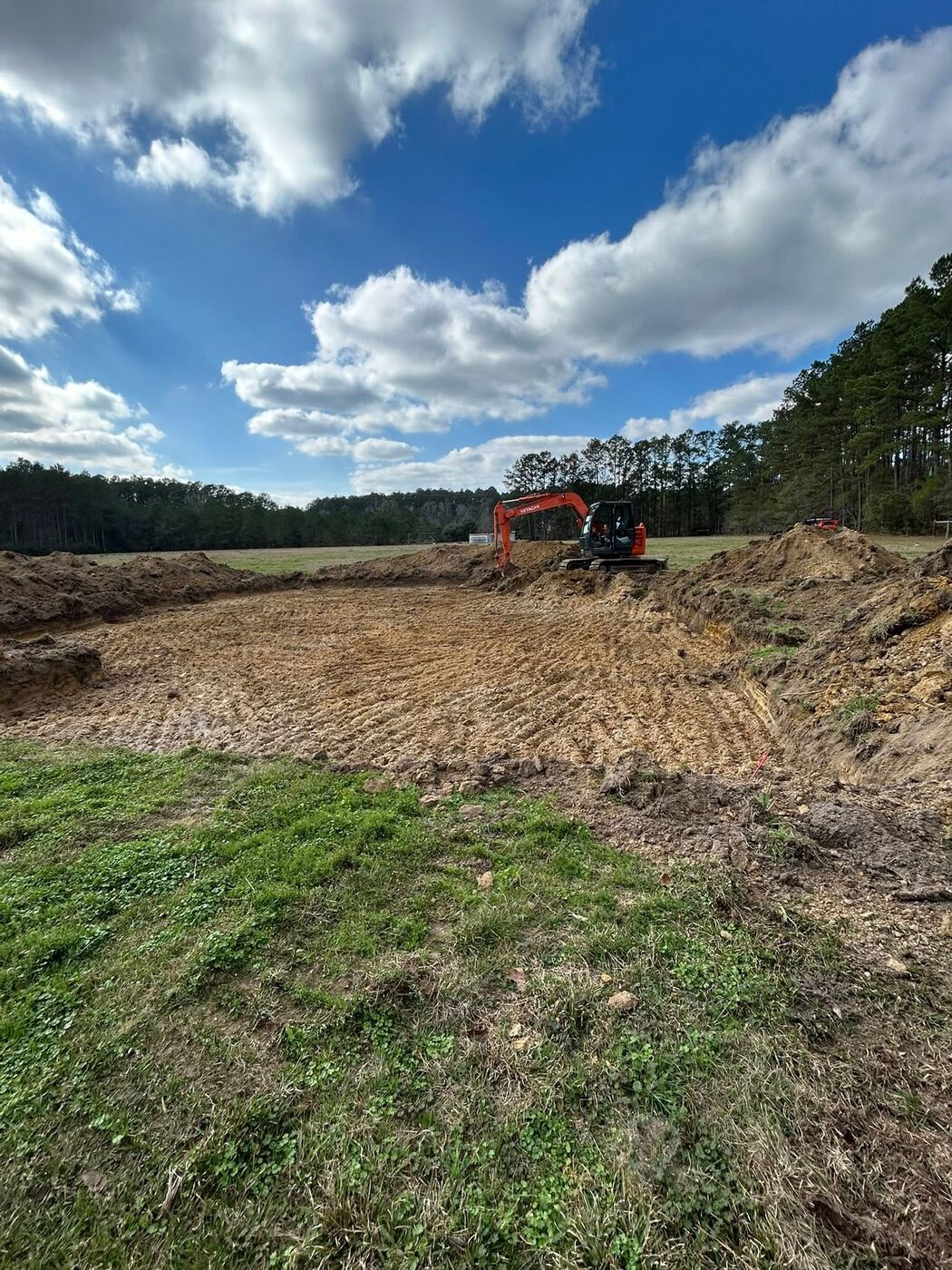 Excavator preparing a cleared building site